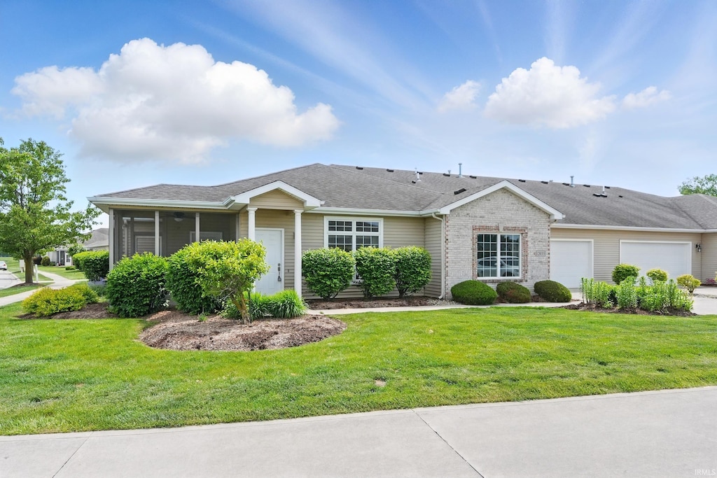 12035 Cross Winds Way, Fort Wayne, IN 46818 - ranch-style house featuring a garage, a sunroom, and a front lawn