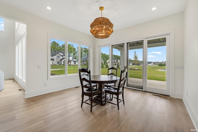 121 Jadis Ct, Fort Wayne, IN 46845 - dining area featuring light wood finished floors, a chandelier, baseboards, recessed lighting, and a residential view