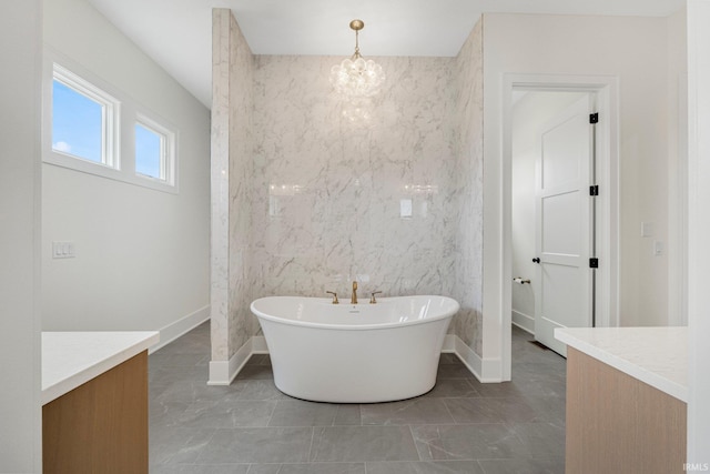 121 Jadis Ct, Fort Wayne, IN 46845 - full bathroom featuring a soaking tub, vanity, a chandelier, and baseboards