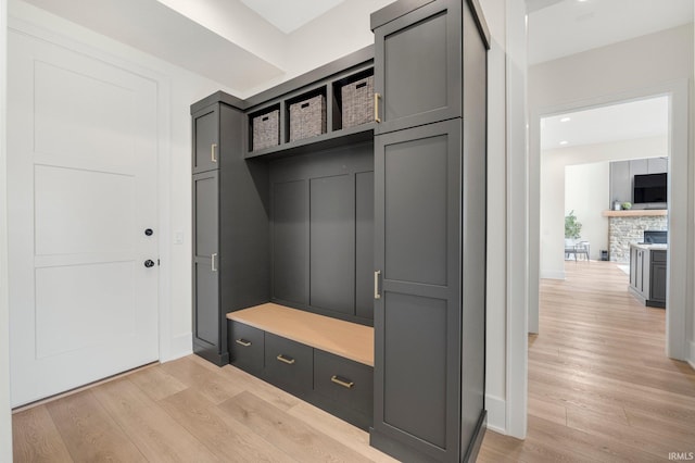 121 Jadis Ct, Fort Wayne, IN 46845 - mudroom featuring light wood-style floors and a fireplace