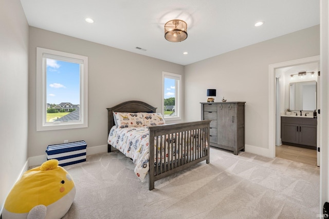 121 Jadis Ct, Fort Wayne, IN 46845 - bedroom with light carpet, baseboards, a sink, recessed lighting, and ensuite bathroom