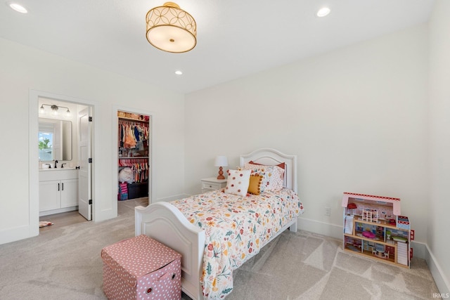 121 Jadis Ct, Fort Wayne, IN 46845 - bedroom featuring light carpet, a spacious closet, a closet, a sink, and connected bathroom