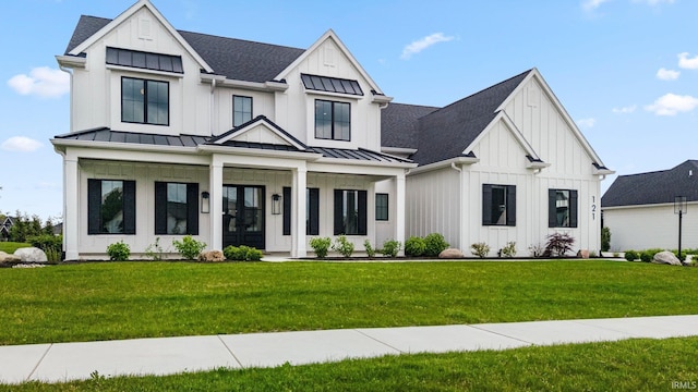 121 Jadis Ct, Fort Wayne, IN 46845 - modern inspired farmhouse featuring board and batten siding, a front yard, a standing seam roof, and roof with shingles