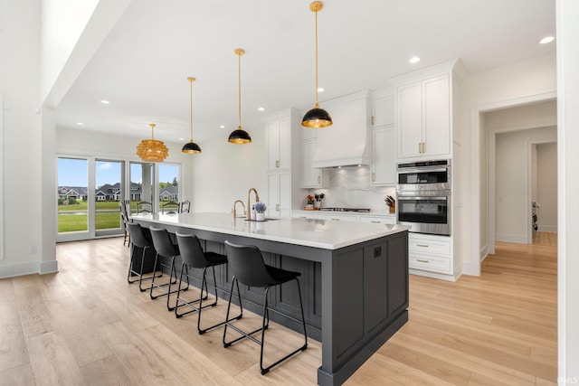 121 Jadis Ct, Fort Wayne, IN 46845 - kitchen with gas cooktop, double oven, white cabinets, light wood-style flooring, and recessed lighting