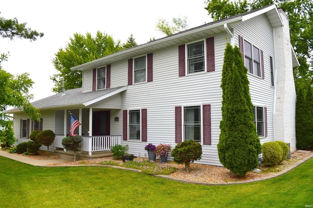 12018 N Woodland Acres Dr, Syracuse, IN 46567 - colonial-style house with covered porch, a front yard, and a chimney