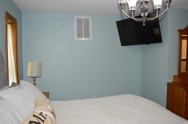 12018 N Woodland Acres Dr, Syracuse, IN 46567 - bedroom featuring a chandelier
