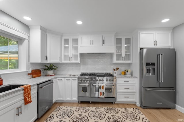 633 S Ravencrest Ave, Bloomington, IN 47401 - kitchen featuring high end appliances, white cabinetry, decorative backsplash, light wood finished floors, and light stone countertops