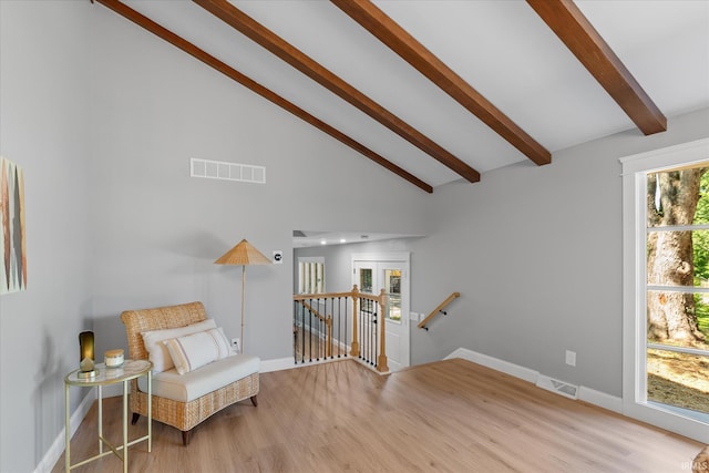 633 S Ravencrest Ave, Bloomington, IN 47401 - sitting room with an upstairs landing, beam ceiling, wood finished floors, baseboards, and high vaulted ceiling