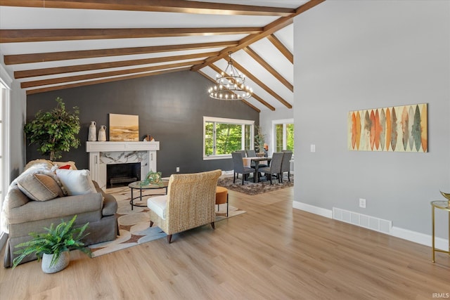 633 S Ravencrest Ave, Bloomington, IN 47401 - living room featuring a chandelier, baseboards, wood finished floors, and a high end fireplace