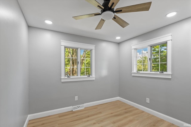 633 S Ravencrest Ave, Bloomington, IN 47401 - spare room with healthy amount of natural light, wood finished floors, baseboards, and recessed lighting