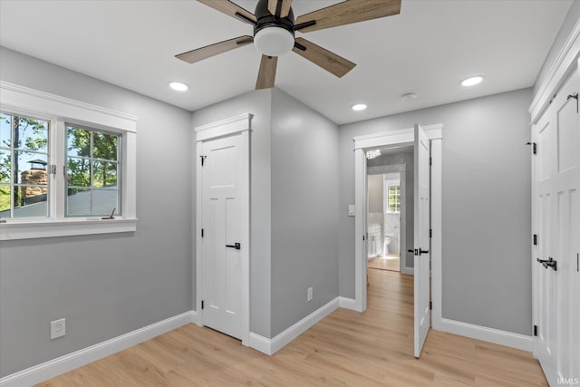 633 S Ravencrest Ave, Bloomington, IN 47401 - unfurnished bedroom with multiple windows, a closet, light wood-style floors, baseboards, and recessed lighting