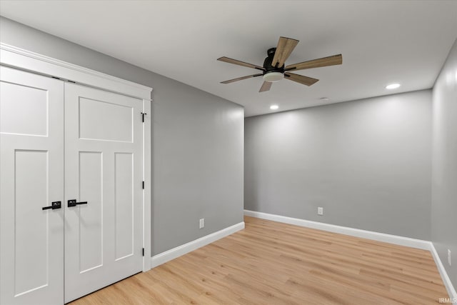 633 S Ravencrest Ave, Bloomington, IN 47401 - unfurnished bedroom with light wood finished floors, baseboards, recessed lighting, and ceiling fan