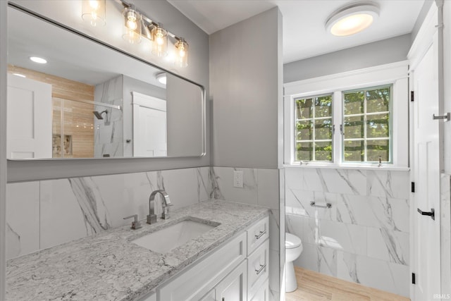633 S Ravencrest Ave, Bloomington, IN 47401 - bathroom with tile walls, vanity, a marble finish shower, and toilet