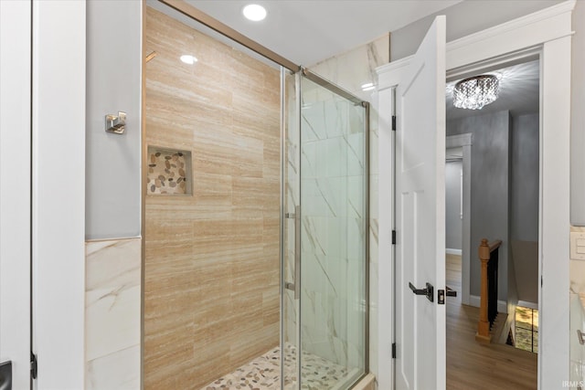 633 S Ravencrest Ave, Bloomington, IN 47401 - bathroom with a marble finish shower, a chandelier, recessed lighting, and wood finished floors