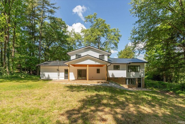 633 S Ravencrest Ave, Bloomington, IN 47401 - back of house with a lawn, metal roof, and a patio area