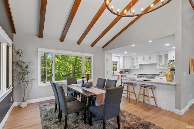 633 S Ravencrest Ave, Bloomington, IN 47401 - dining area with light wood finished floors, plenty of natural light, a chandelier, baseboards, and beam ceiling