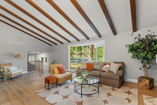 633 S Ravencrest Ave, Bloomington, IN 47401 - living room with beam ceiling, wood finished floors, baseboards, and high vaulted ceiling