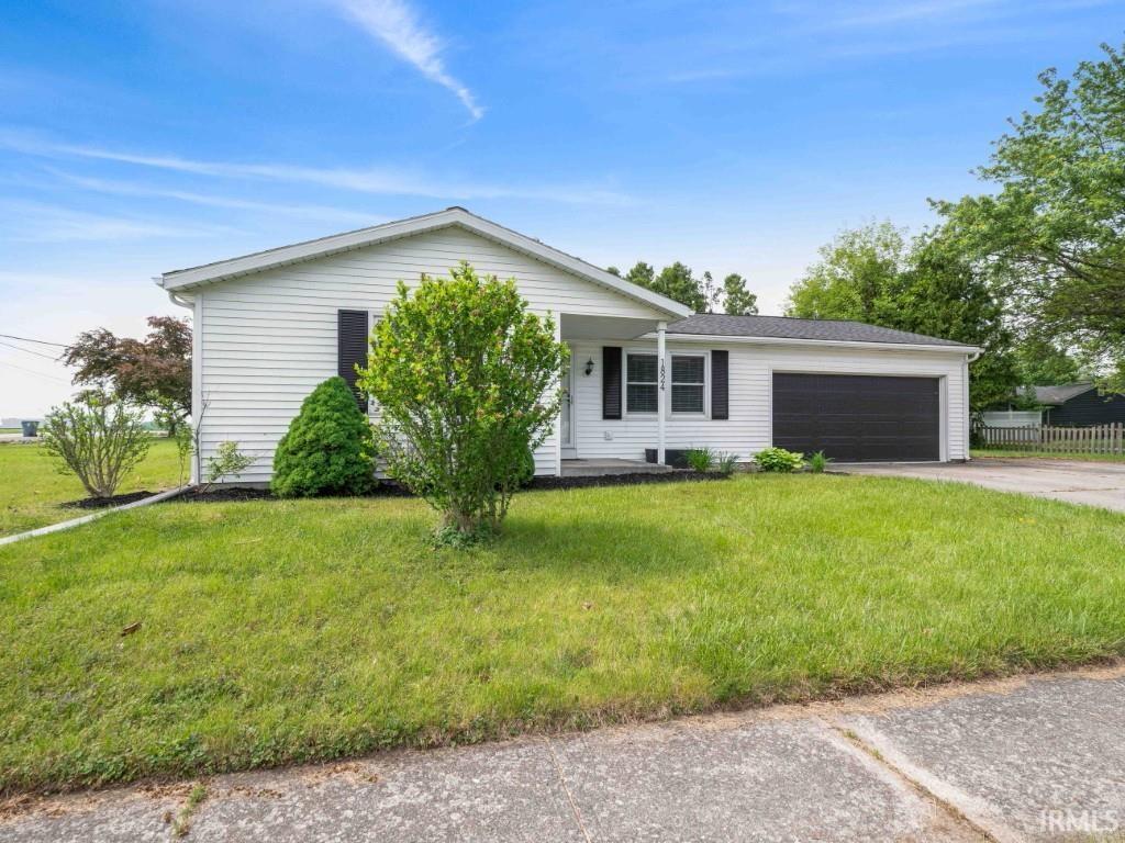 1824 Cameron Ln, New Haven, IN 46774 - view of front facade featuring driveway, a garage, and a front yard