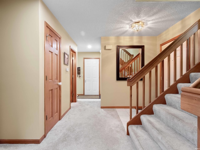 10215 Tidewater Trl, Fort Wayne, IN 46845 - entryway with stairs, carpet floors, baseboards, and a textured ceiling