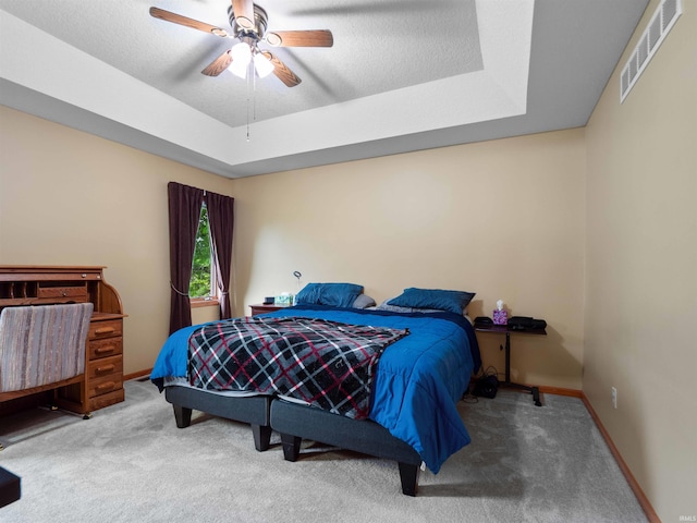 10215 Tidewater Trl, Fort Wayne, IN 46845 - bedroom with carpet flooring, a tray ceiling, baseboards, and a ceiling fan
