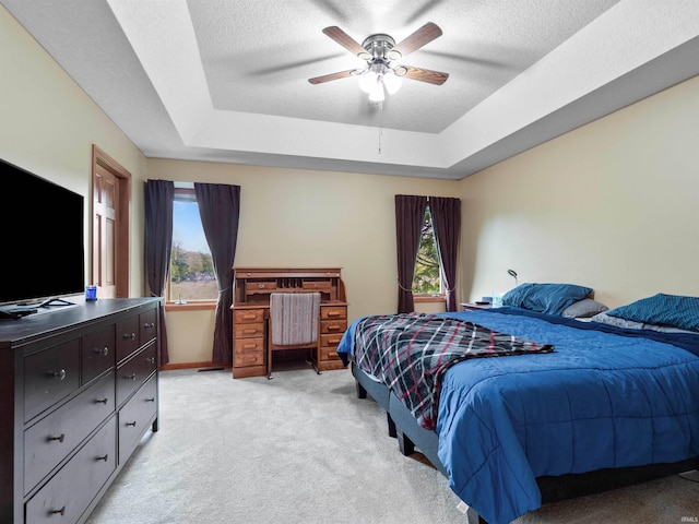 10215 Tidewater Trl, Fort Wayne, IN 46845 - bedroom with a tray ceiling, light colored carpet, multiple windows, a textured ceiling, and a ceiling fan