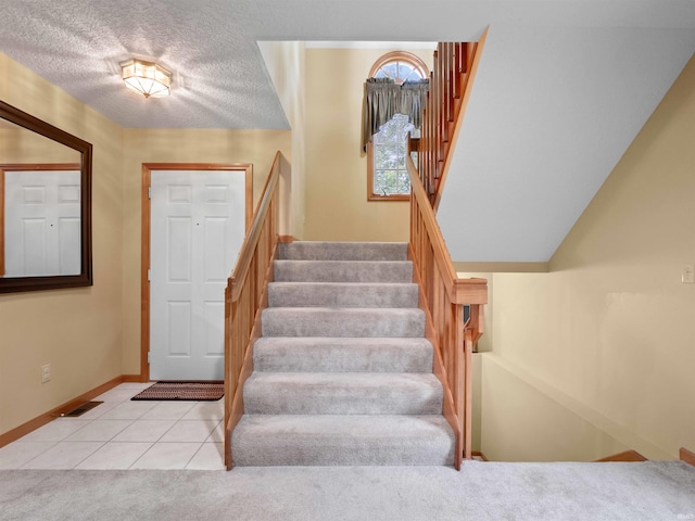 10215 Tidewater Trl, Fort Wayne, IN 46845 - stairs featuring tile patterned flooring, baseboards, carpet, and a textured ceiling