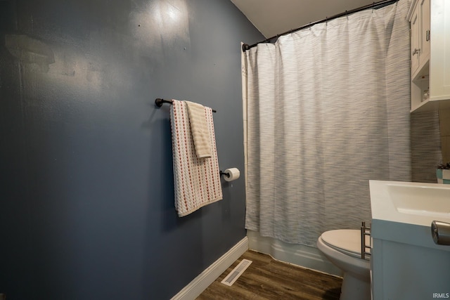 113 W Berkeley Ave, Evansville, IN 47710 - full bathroom with wood finished floors, toilet, vanity, baseboards, and shower / tub combo with curtain