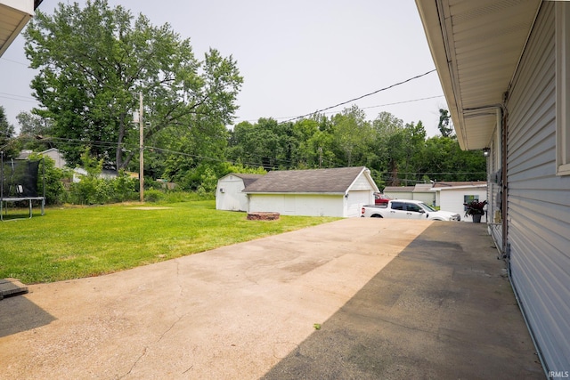 113 W Berkeley Ave, Evansville, IN 47710 - view of patio / terrace with a trampoline, an outdoor structure, and concrete driveway