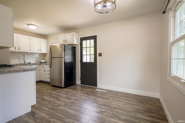 113 W Berkeley Ave, Evansville, IN 47710 - kitchen with freestanding refrigerator, healthy amount of natural light, baseboards, and white cabinets