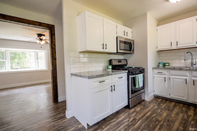 113 W Berkeley Ave, Evansville, IN 47710 - kitchen featuring stainless steel appliances, a sink, dark wood-style floors, and tasteful backsplash