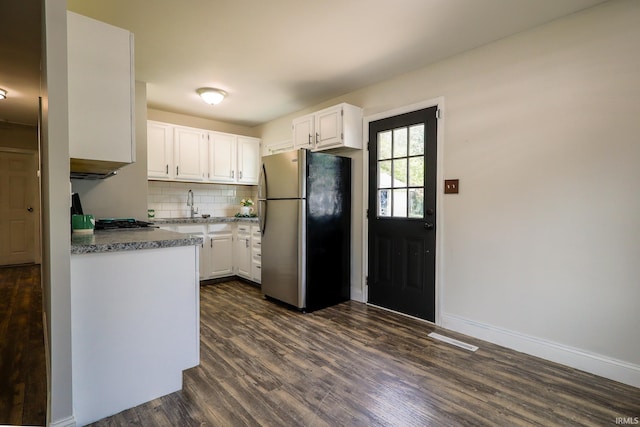 113 W Berkeley Ave, Evansville, IN 47710 - kitchen with freestanding refrigerator, white cabinetry, dark wood-type flooring, tasteful backsplash, and a sink