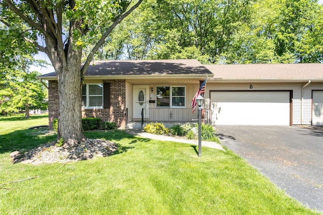 5709 Bayswater Ct, South Bend, IN 46614 - single story home with asphalt driveway, a front lawn, an attached garage, brick siding, and covered porch