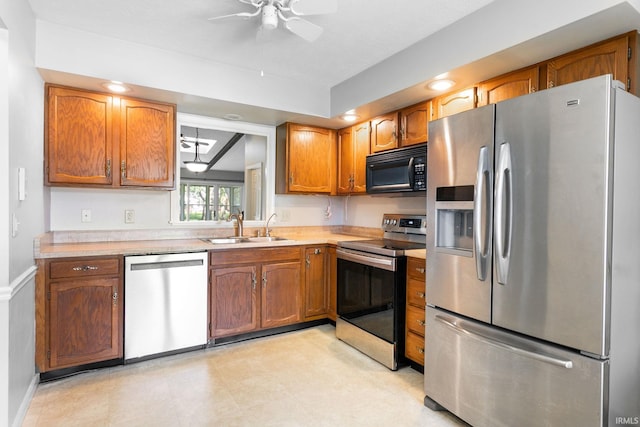 5709 Bayswater Ct, South Bend, IN 46614 - kitchen with appliances with stainless steel finishes, a sink, a ceiling fan, light countertops, and brown cabinets