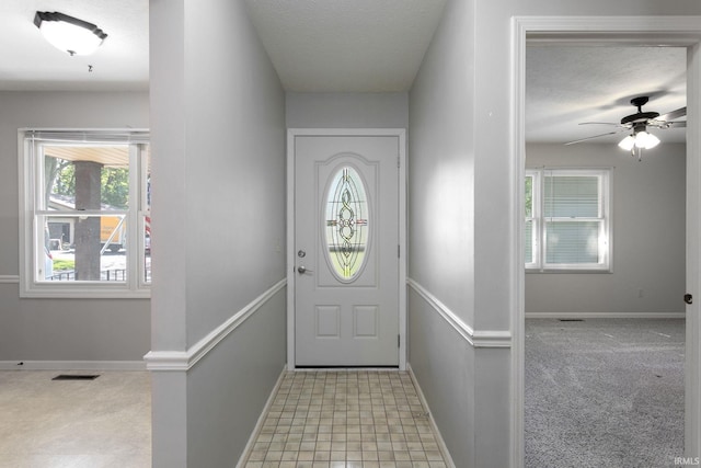 5709 Bayswater Ct, South Bend, IN 46614 - entryway featuring healthy amount of natural light, baseboards, ceiling fan, and a textured ceiling