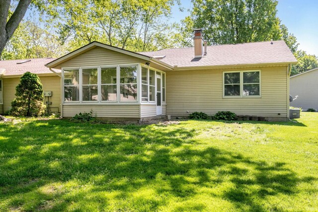 5709 Bayswater Ct, South Bend, IN 46614 - back of property with a chimney, a lawn, a sunroom, and a shingled roof