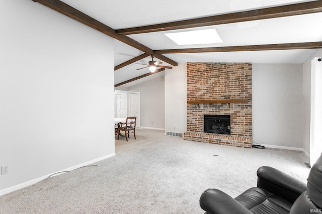5709 Bayswater Ct, South Bend, IN 46614 - living area with carpet flooring, a ceiling fan, baseboards, a fireplace, and a skylight