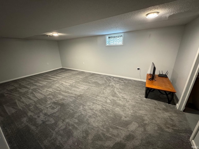 1414 Spear St, Rochester, IN 46975 - below grade area featuring dark carpet, a textured ceiling, and baseboards