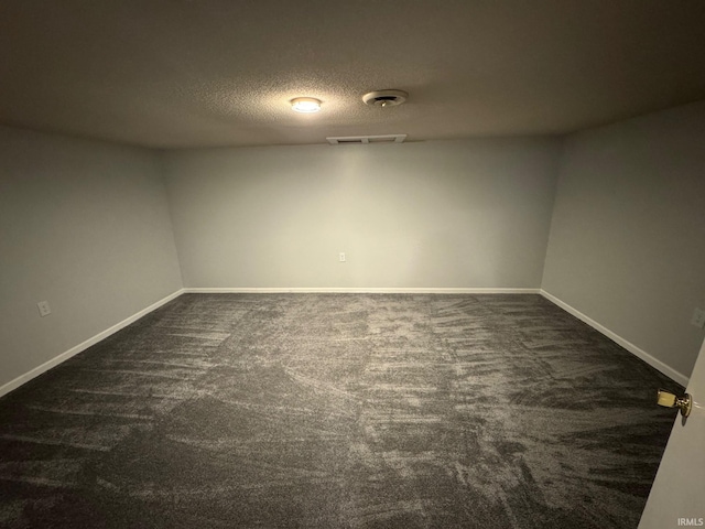 1414 Spear St, Rochester, IN 46975 - empty room featuring dark colored carpet, a textured ceiling, and baseboards