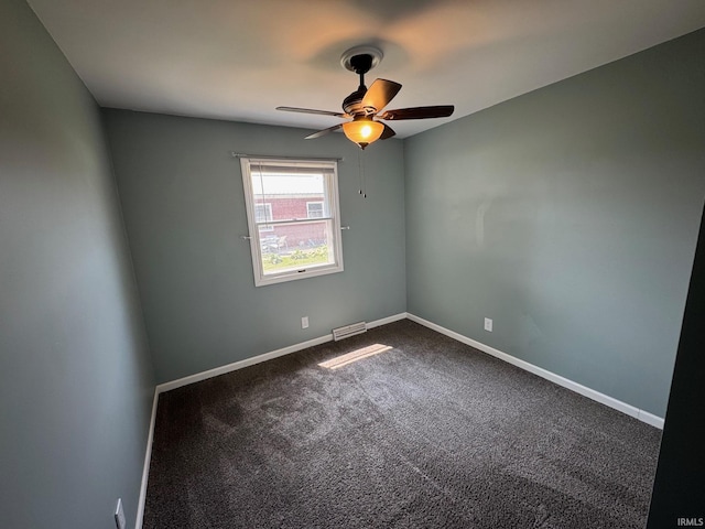 1414 Spear St, Rochester, IN 46975 - empty room with ceiling fan, dark carpet, and baseboards