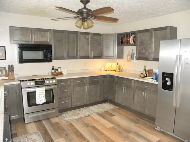 3116 Truesdel Rd, Gosport, IN 47433 - kitchen featuring stainless steel appliances, light countertops, a textured ceiling, a ceiling fan, and light wood-style floors