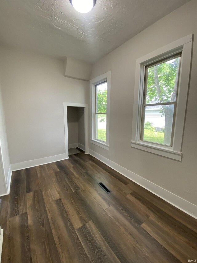 1824 Boxcar Ln, Auburn, IN 47606 - empty room with baseboards, dark wood-style floors, and a textured ceiling