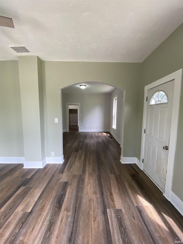 1824 Boxcar Ln, Auburn, IN 47606 - entryway featuring arched walkways, dark wood-type flooring, plenty of natural light, and baseboards