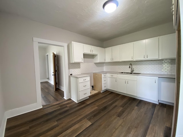 1824 Boxcar Ln, Auburn, IN 47606 - kitchen featuring a sink, backsplash, dark wood-type flooring, white cabinets, and a textured ceiling