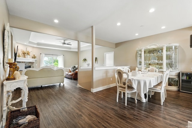 17009 Hamptons Pkwy, New Haven, IN 46774 - dining space featuring a ceiling fan, dark wood finished floors, recessed lighting, baseboards, and a fireplace