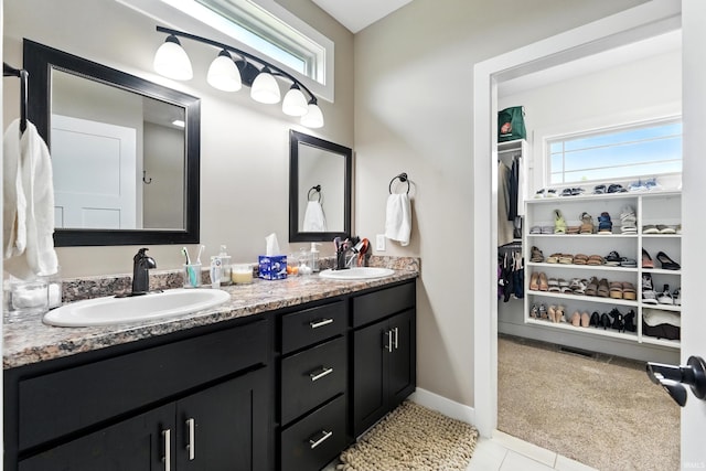 17009 Hamptons Pkwy, New Haven, IN 46774 - full bath featuring double vanity, a spacious closet, tile patterned flooring, and baseboards