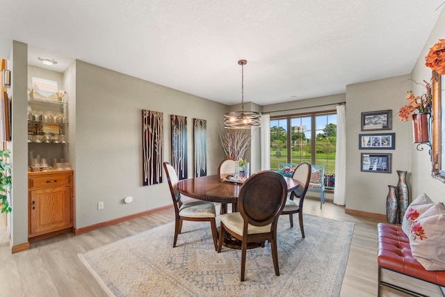 6378 N 100 E, Ossian, IN 46777 - dining room with light wood-style flooring, baseboards, and a chandelier