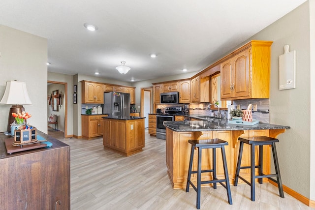 6378 N 100 E, Ossian, IN 46777 - kitchen with appliances with stainless steel finishes, a sink, baseboards, a peninsula, and recessed lighting