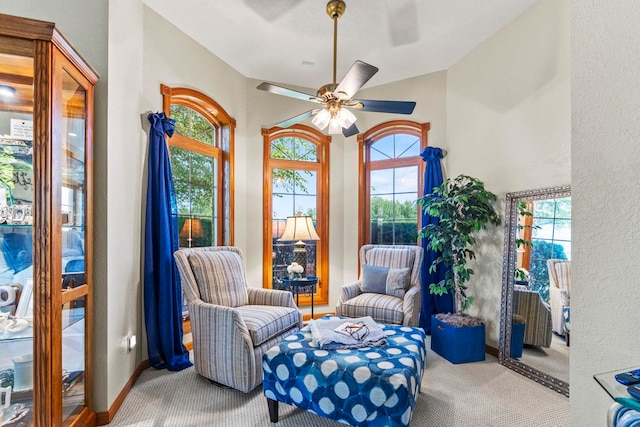 6378 N 100 E, Ossian, IN 46777 - living area featuring carpet floors, a ceiling fan, a textured wall, vaulted ceiling, and baseboards