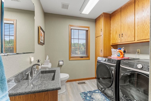 6378 N 100 E, Ossian, IN 46777 - laundry room with light wood-style flooring, washing machine and dryer, baseboards, and a textured wall