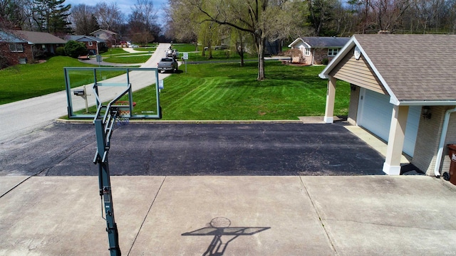 4604 Mayfield Dr, Kokomo, IN 46901 - view of home's community featuring a garage, a lawn, and driveway
